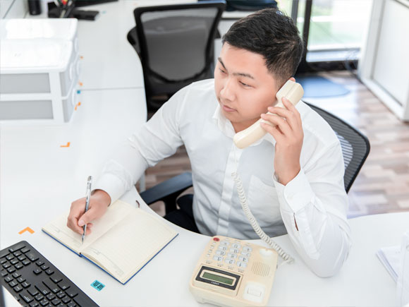 the customer service staff is communicating with the clients via the phone